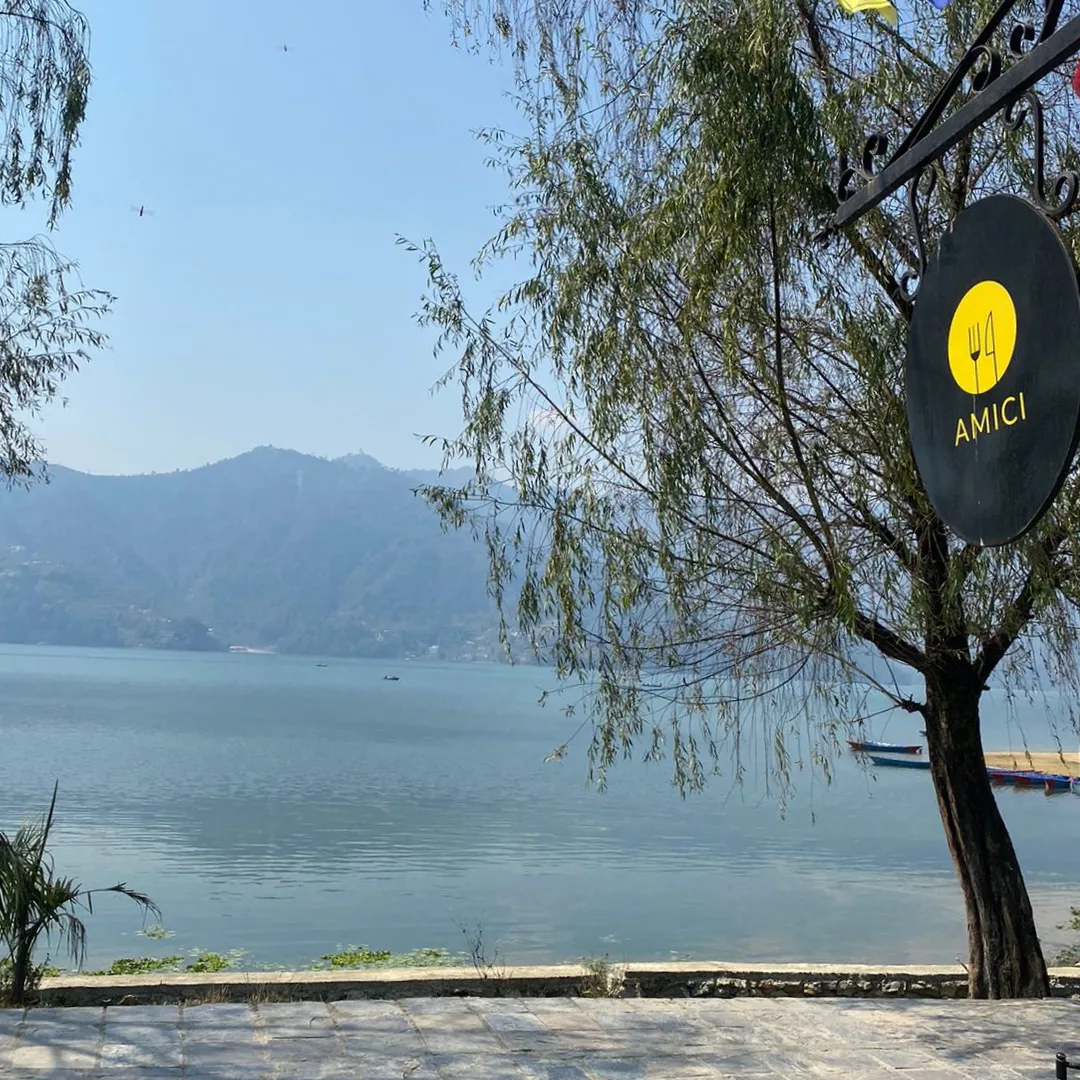 Fewa Lake from the lake-walk with the yellow Amici sign hanging from a willow tree
